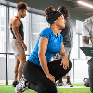 Woman training at the gym with a coach, representing fitness enthusiasts and audiences interested in sports, wellness, and healthy living.