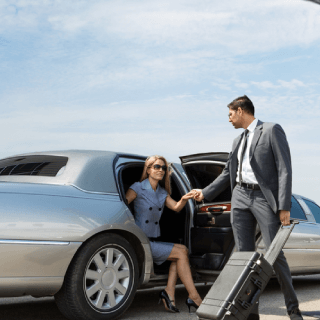 Business travelers stepping out of a luxury car, representing high-income audiences interested in premium travel, lifestyle, and exclusive experiences.